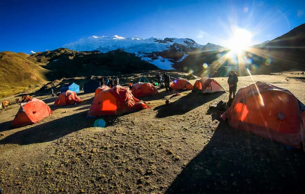 Orange tents at a campsite below the Ausangate glacier