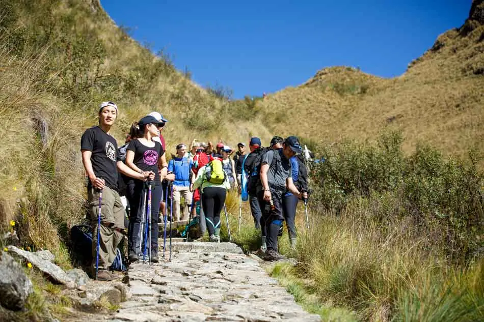 Group climbing the stone steps toward Warmiwañusca (Dead Woman's Pass) on day two