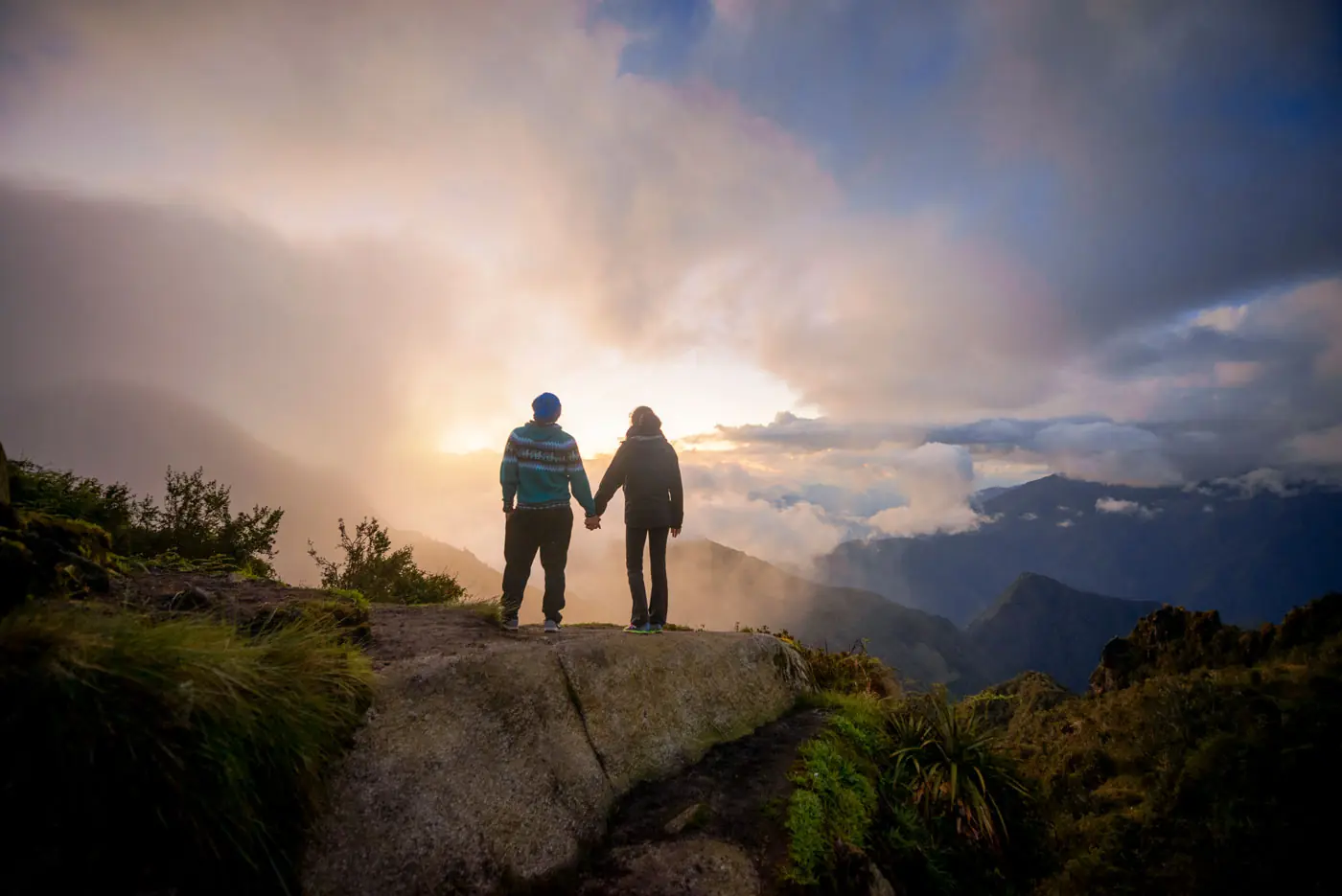 Two hikers watching the sunset over the Andes near Phuyupatamarca