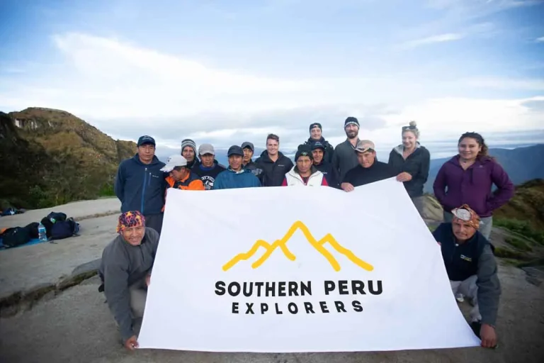Southern Peru Explorers trekking team holding the company banner