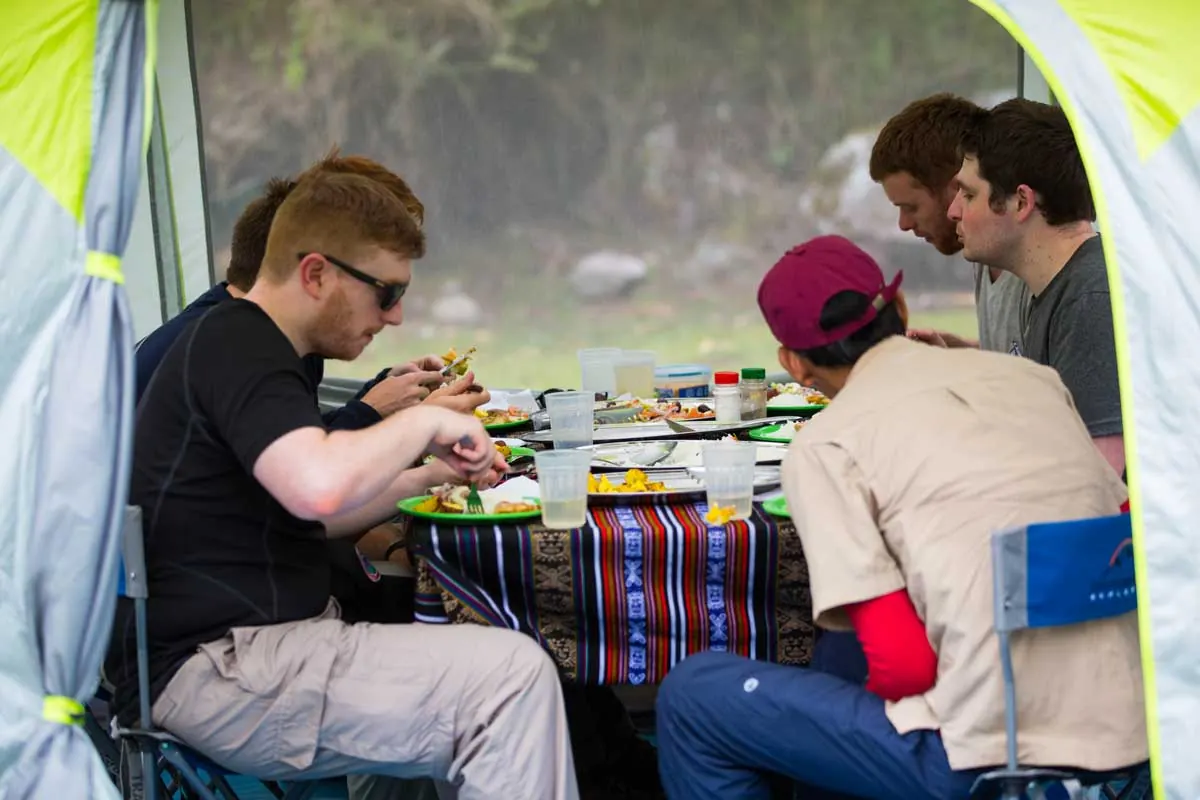 Travelers having lunch in a dining tent