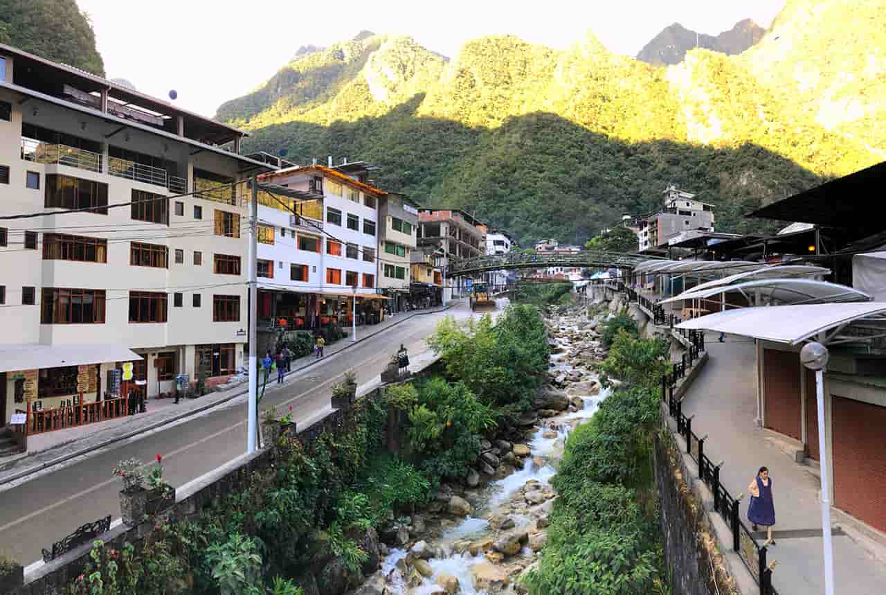Machu Picchu Pueblo (Aguas Calientes) in Peru with colorful buildings, mountain scenery, train station, and Urubamba River, Experience Peru?s Most Exciting Route to Machu Picchu