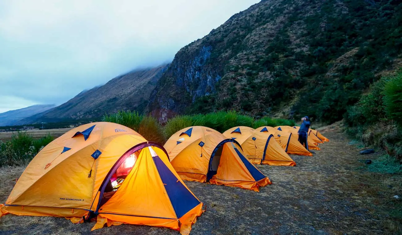 Orange tents at a campsite on the Salkantay route