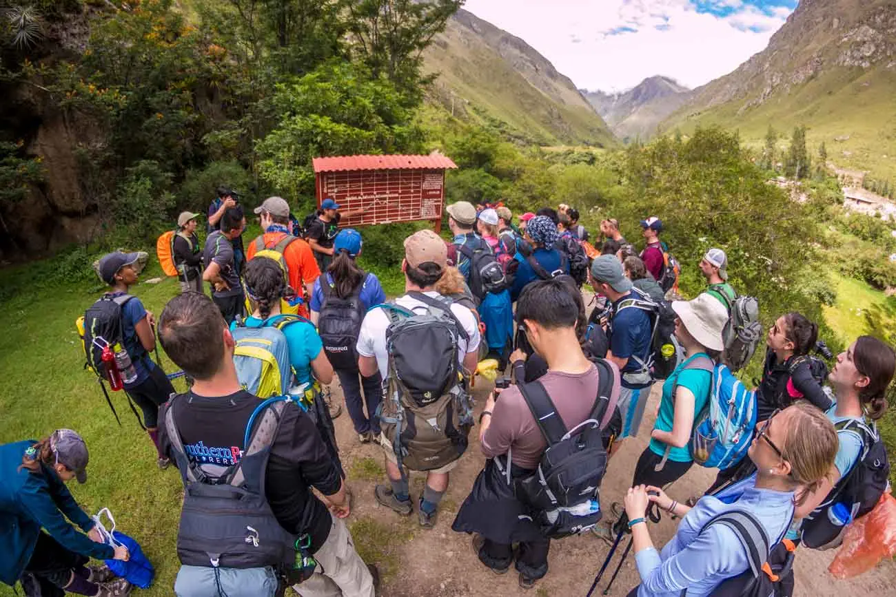 Guide giving a briefing to a large group of trekkers