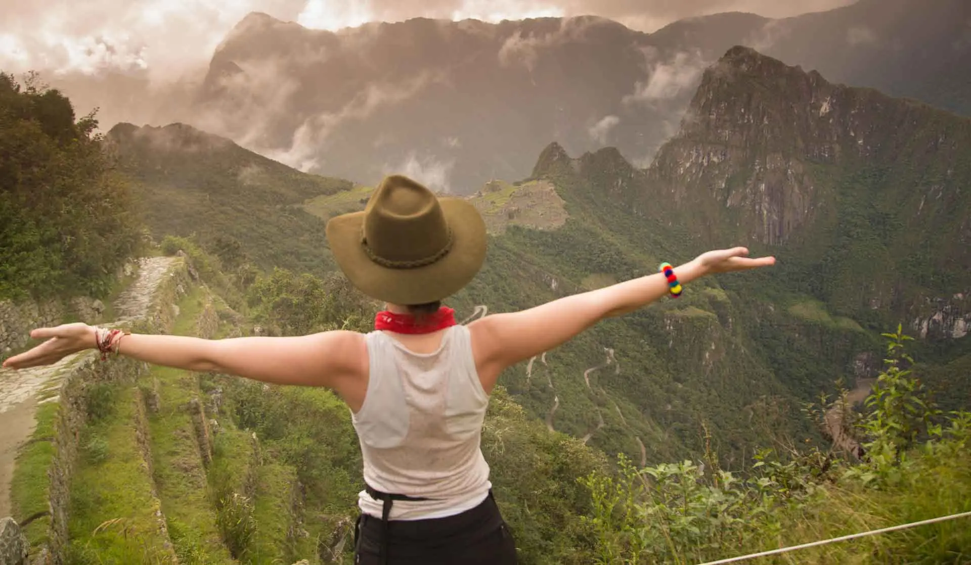 Hiker with open arms looking over the Machu Picchu valley on the Short Inca Trail