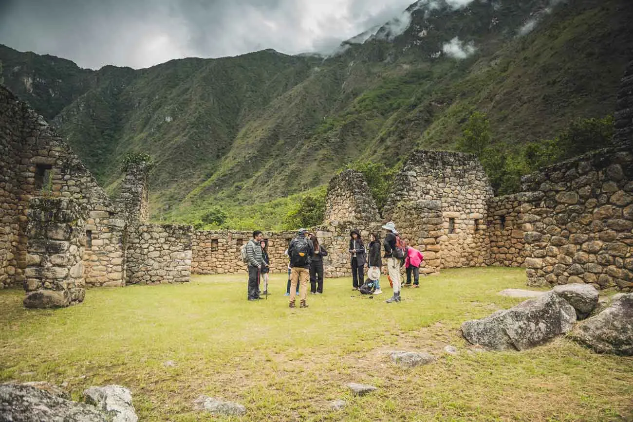 Guided group visiting the Chachabamba Inca ruins on the Short Inca Trail