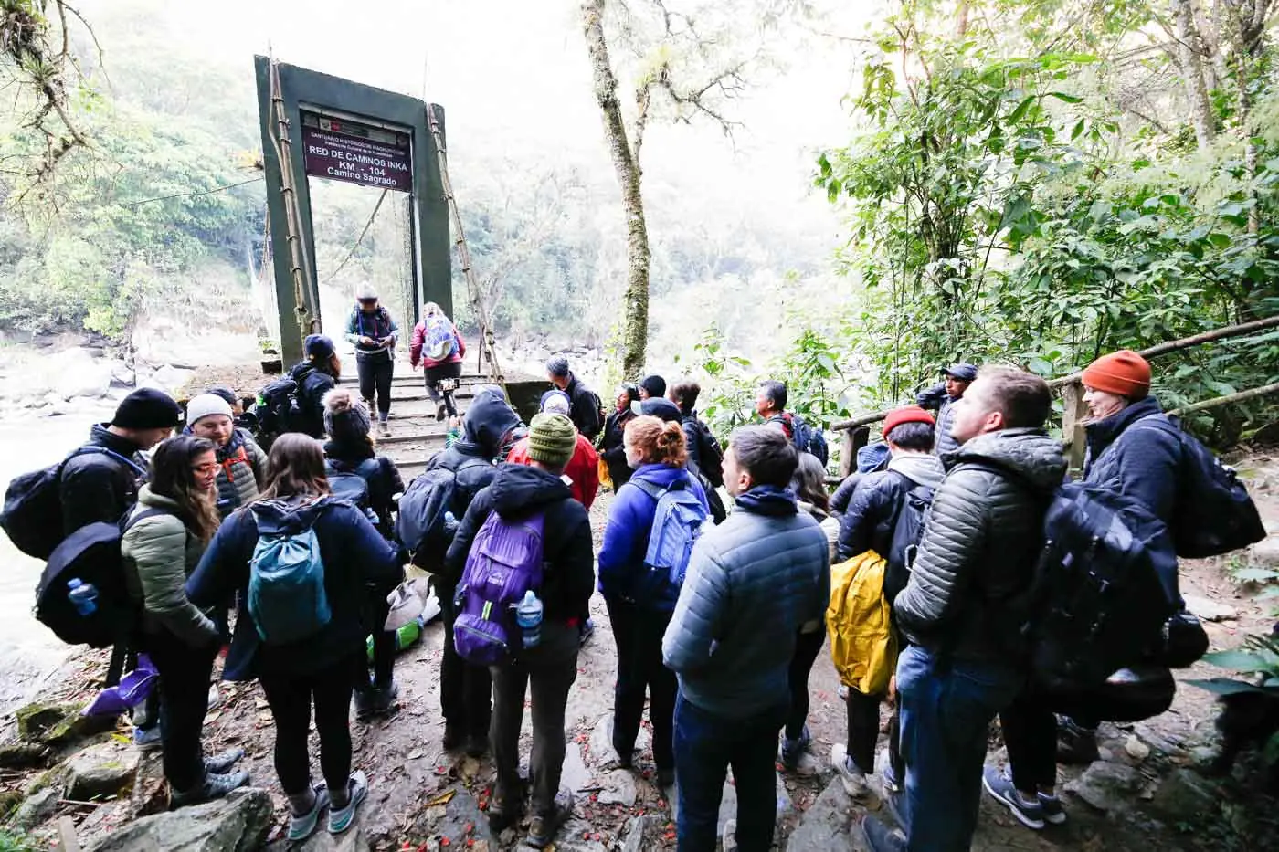 Hikers crossing the bridge at Km 104, start of the Short Inca Trail