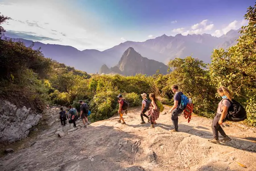 Hikers on the last stretch of the Short Inca Trail with Machu Picchu in view