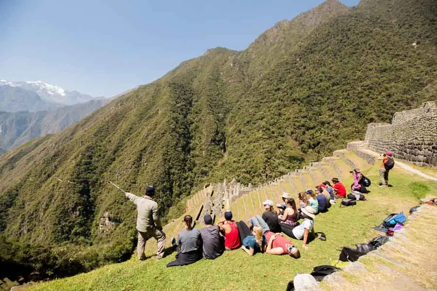 Hikers resting on the terraces of Wiñay Wayna
