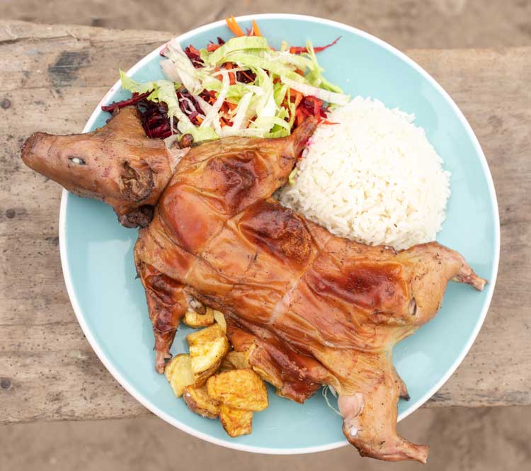 Cuy Chactado from Cusco Peru, fried guinea pig served with potatoes, corn, and traditional Andean side dishes