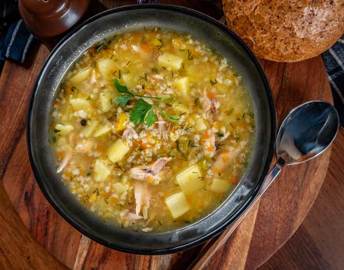 Quinoa soup from Cusco, Peru served with vegetables, herbs, and Andean ingredients in a traditional bowl