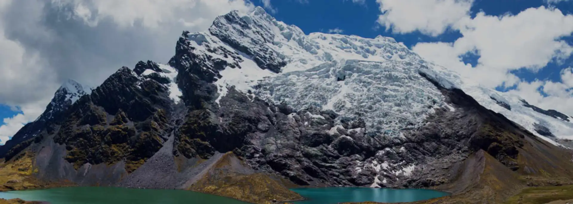 Ausangate Trek F.A.Q. Ausangate Trek in Peru with snowy mountains, high-altitude trails, and hikers in the Andes landscape near Cusco