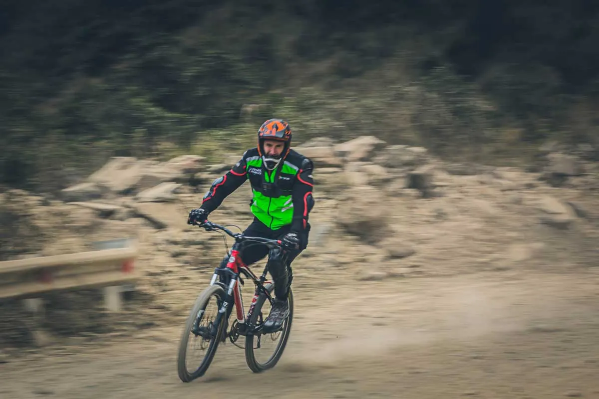 Mountain biker riding downhill on a dirt road
