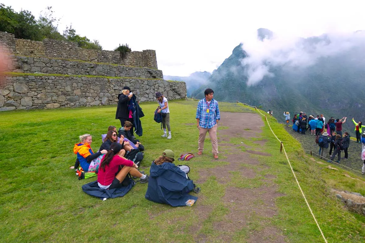 Group resting on the grass at Machu Picchu