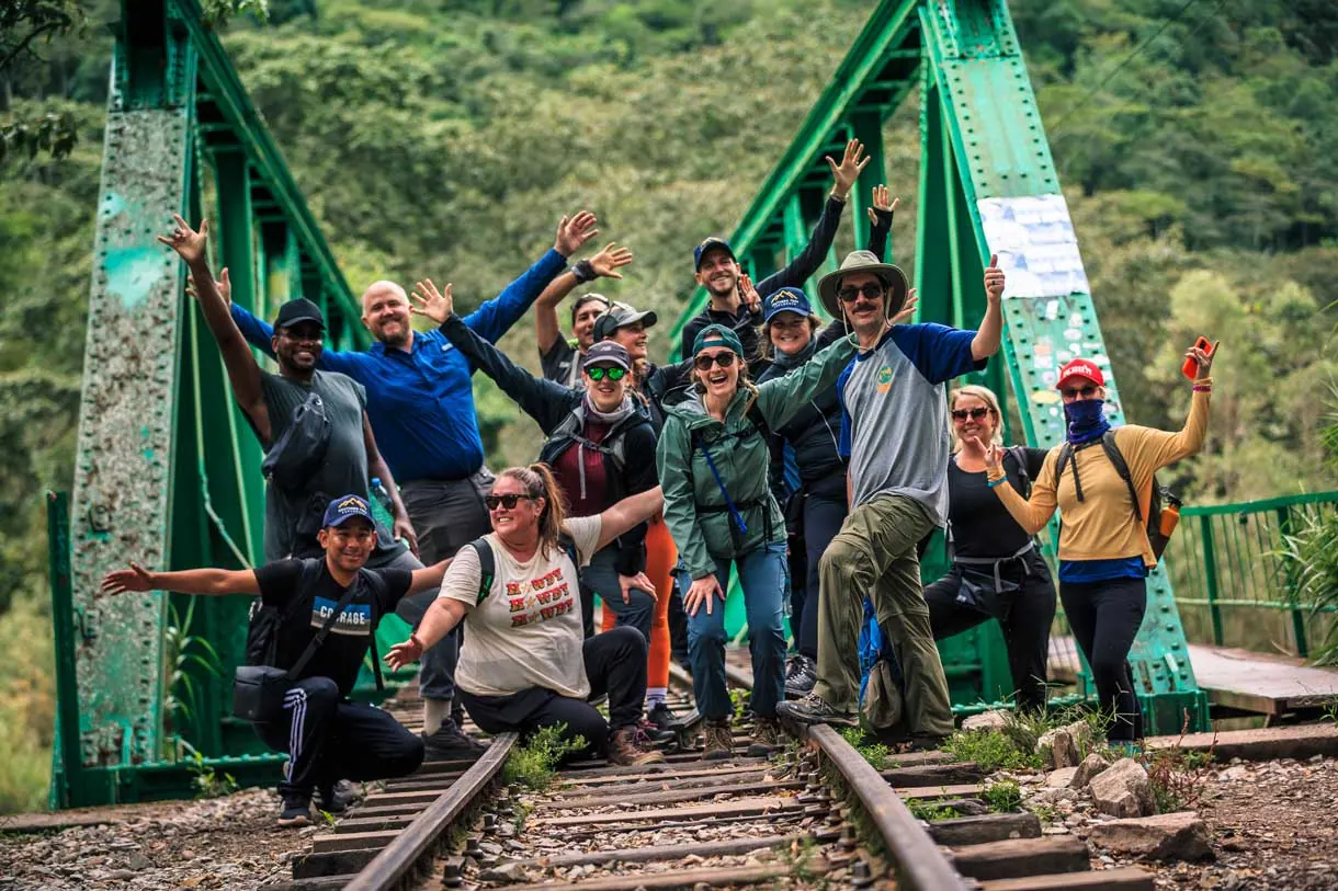 Group posing on a railway bridge on the way to Aguas Calientes
