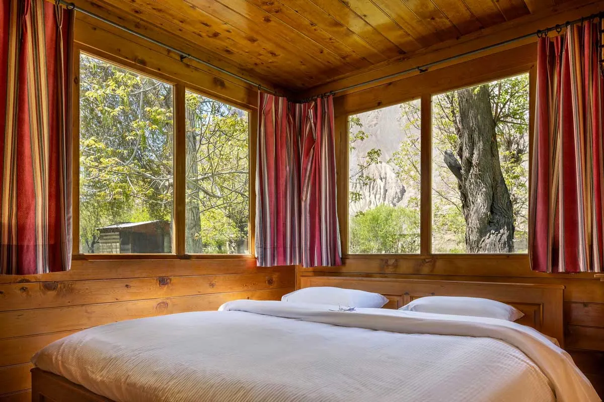 Lodge bedroom with a double bed and large windows