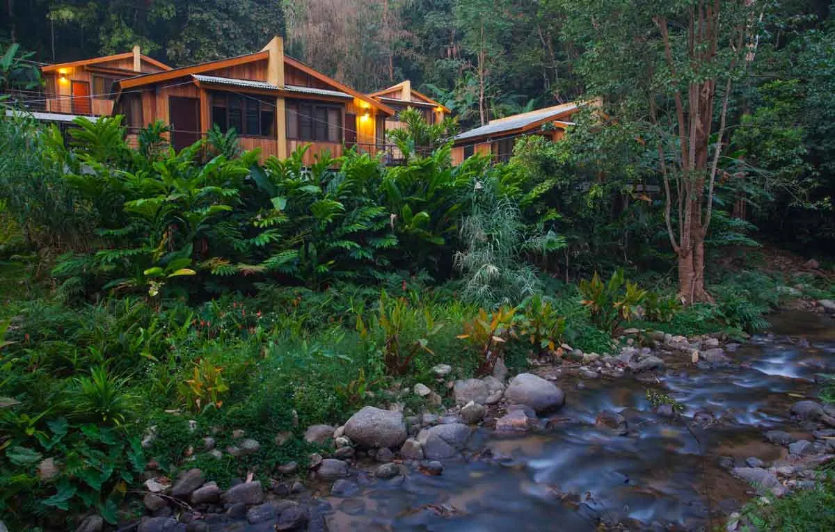 Wooden lodge beside a river in the forest