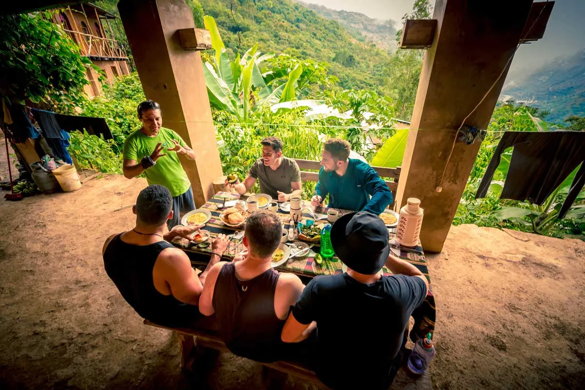 Travelers having lunch at a table under a roof