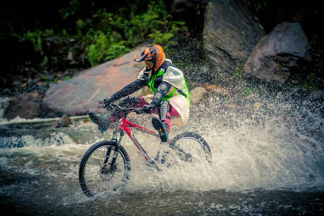 Mountain biker splashing through a stream