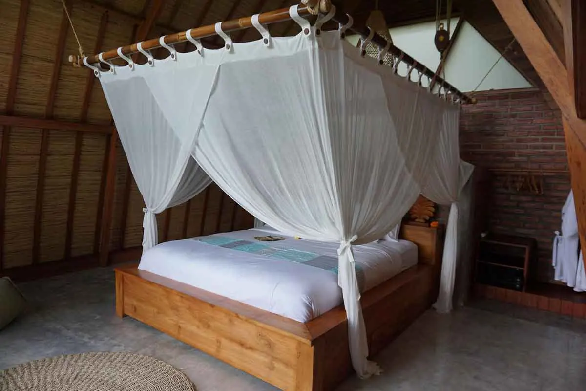 Lodge bedroom with a canopy bed and mosquito net
