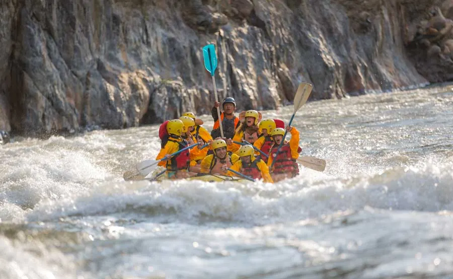 Raft going through white water in a rocky gorge