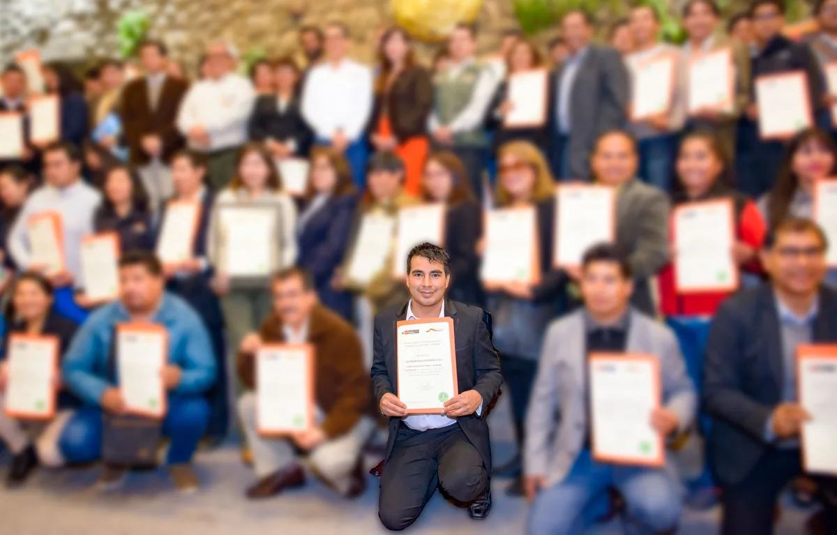 Joel Cárdenas Gonzales holding a certificate at a ceremony