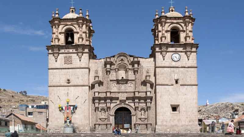 Puno City in Peru overlooking Lake Titicaca with traditional architecture, vibrant streets, and Andean mountain scenery